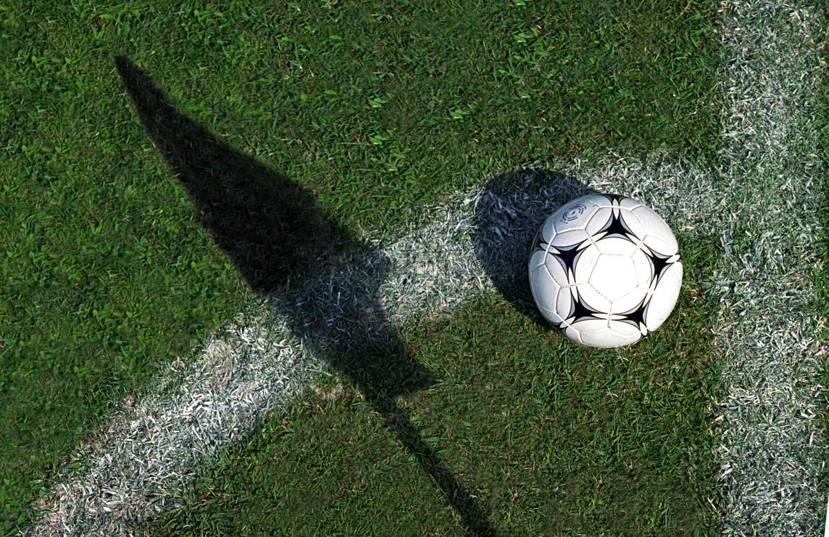 A football sits on a grass pitch in this undated creative image. York Regional Police say a 23-year-old man is facing charges of sexual assault over an incident during a soccer lesson in Vaughan on Aug. 18, 2026.