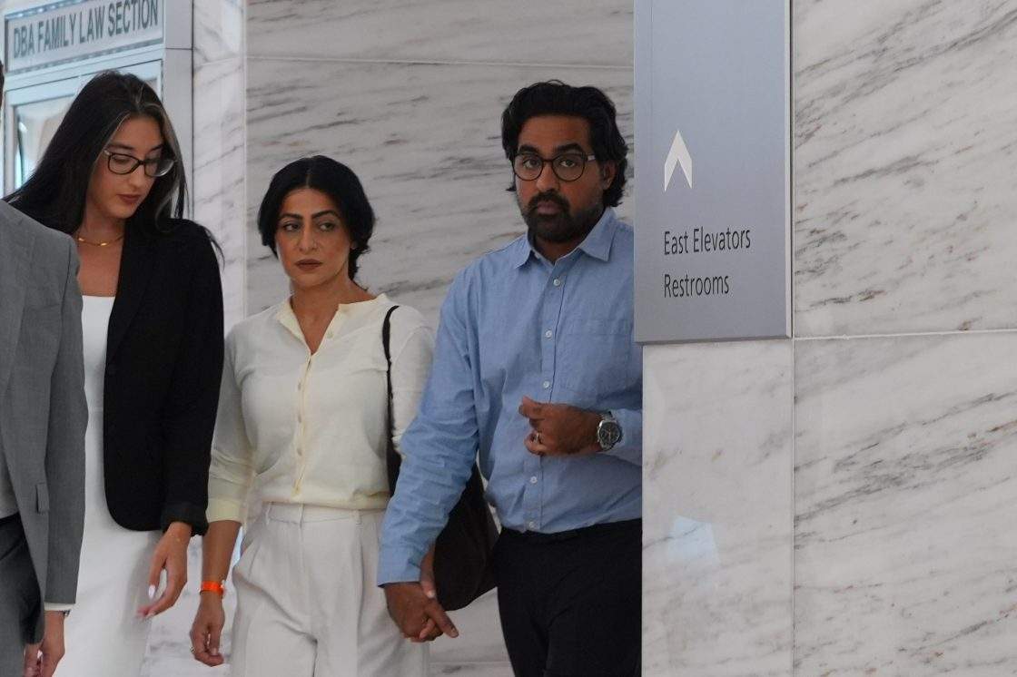 Omar Ahmed, right, and his wife Nausheen Gilkar, center, arrive for a court hearing in Dallas, Tuesday, Aug. 25, 2026.