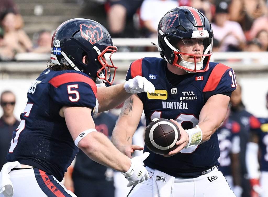Montreal Alouettes quarterback Davis Alexander (10) hands off to Travis Theis (5) during second half CFL football action against the Edmonton Elks in Montreal, on Saturday, August 8, 2026. THE CANADIAN PRESS/Graham Hughes.