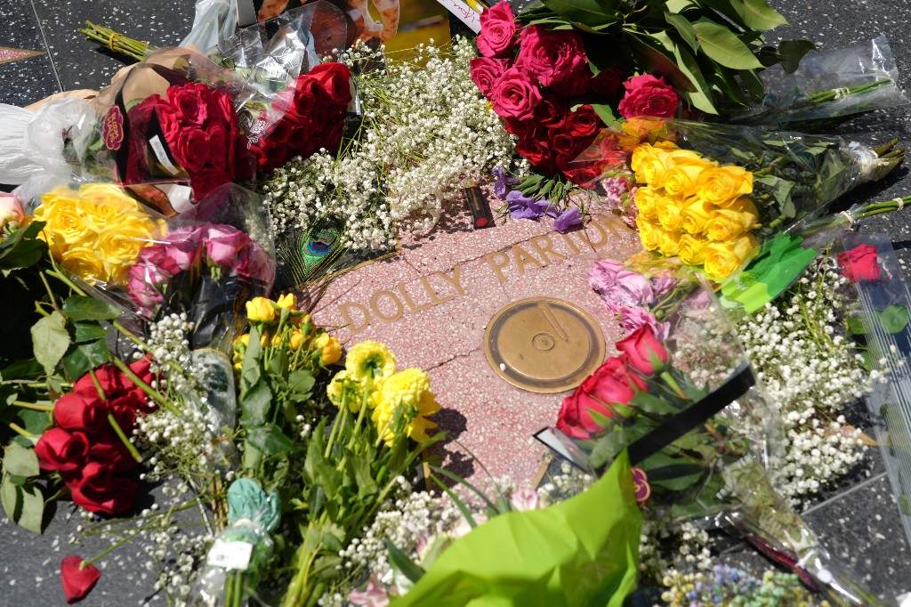 Dolly Parton's star on the Hollywood Walk of Fame is decorated with flowers Tuesday, Aug. 25, 2026, in Los Angeles.