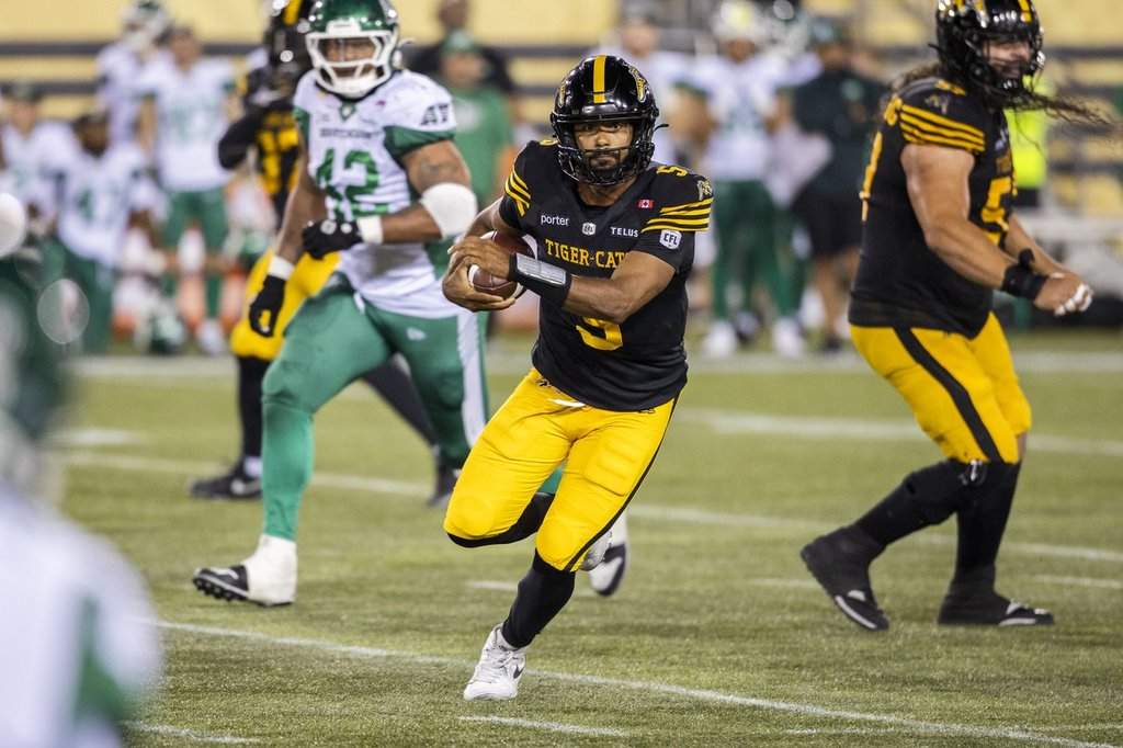 Hamilton Tiger-Cats quarterback Tre Ford (5) runs the ball during second half CFL action against the Saskatchewan Roughriders in Hamilton, Saturday, Aug. 15, 2026. THE CANADIAN PRESS/Nick Iwanyshyn.