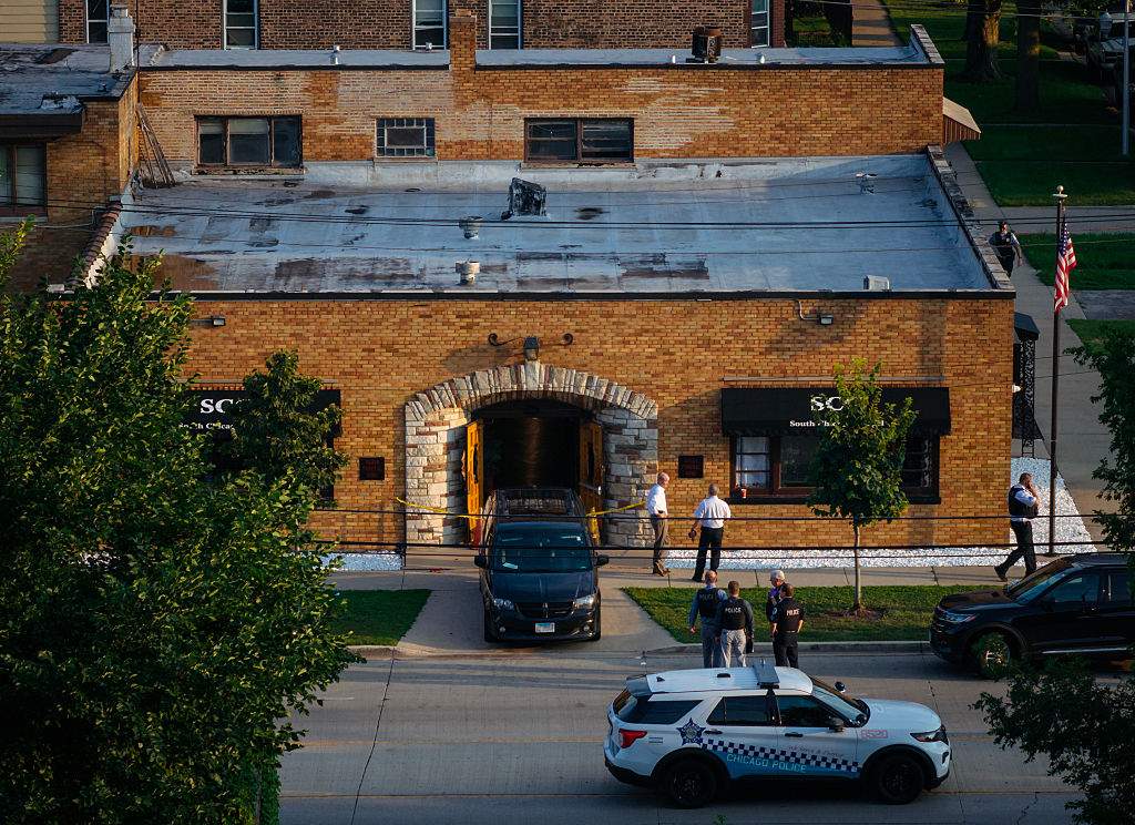 Officials work outside South Chicago Chapel funeral home where dozens of bodies were found on Thursday, Aug. 6, 2026, in Chicago.