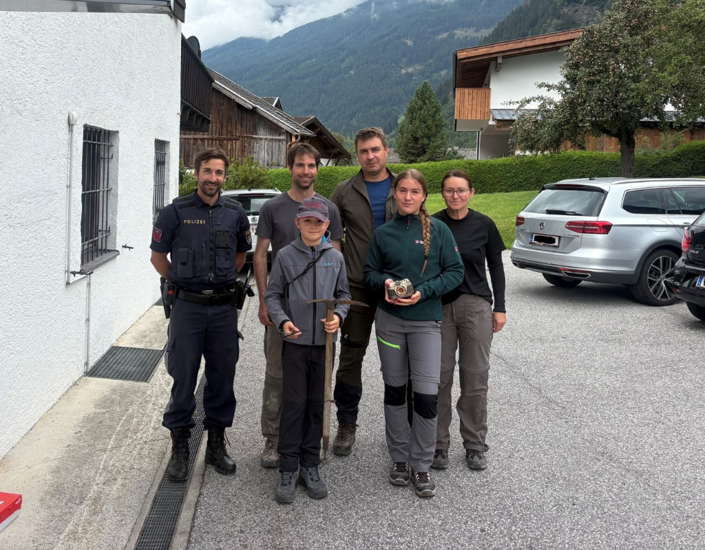 The family of an 86-year-old mountaineer who lost his backpacking equipment in a near fatal accident 60 years ago pose with the items after the were unexpectedly retrieved by a hiker in August 2026.