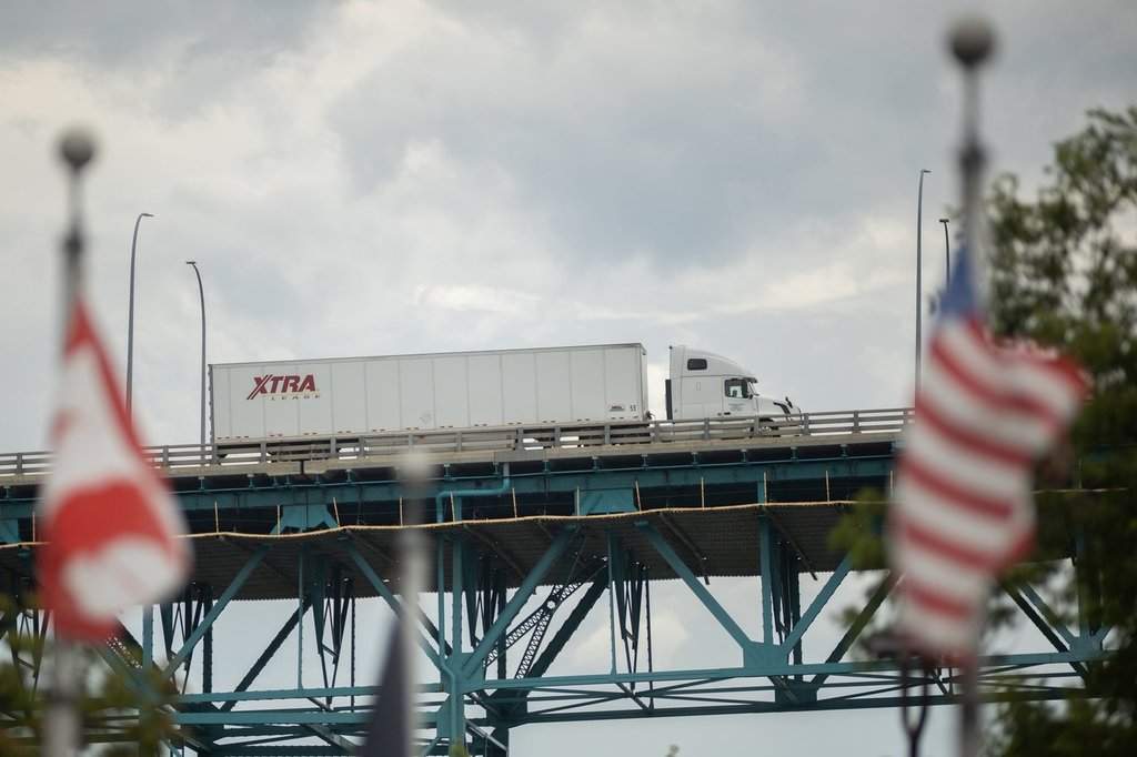 Transport trucks cross the Ambassador Bridge into the United States of America, in Windsor, Ont., Saturday, Aug. 22, 2026. THE CANADIAN PRESS/Dax Melmer.