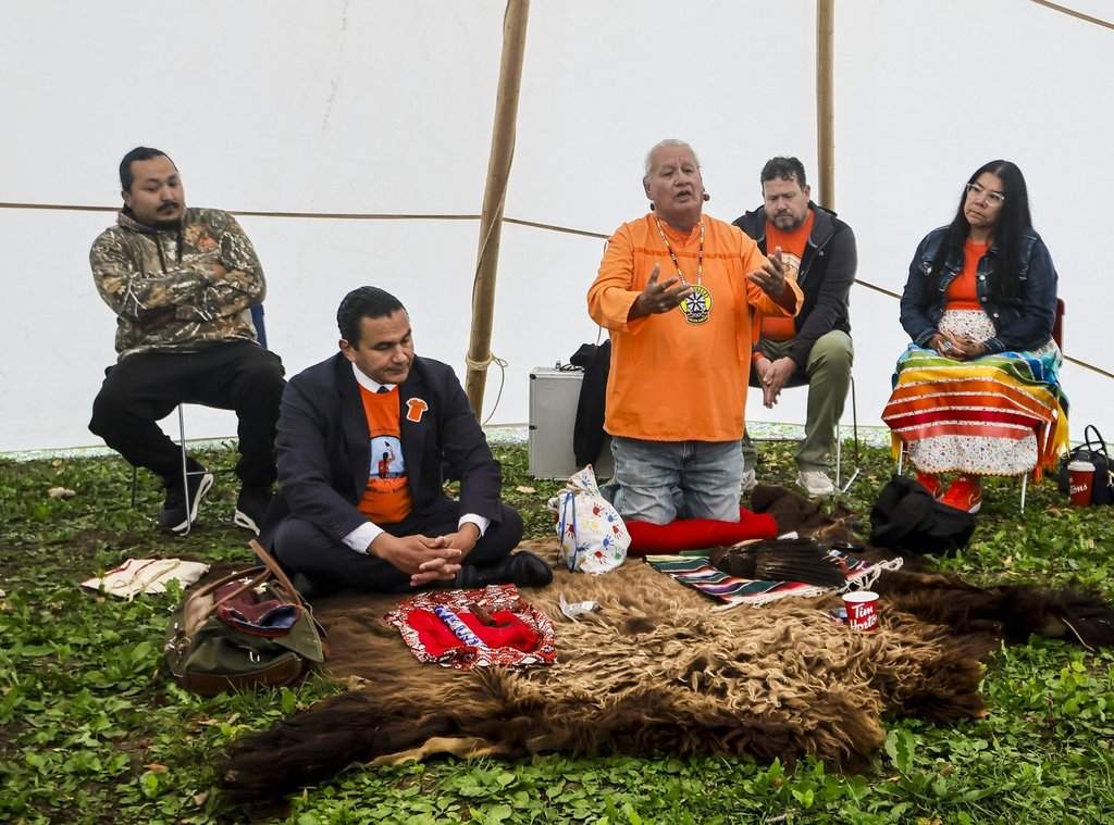 Premier Wab Kinew and elder Frank Tacan participate in a ceremony to hand over campground land to Sioux Valley Dakota Nation in Brandon, Manitoba, on Wednesday, September 30, 2026. The land was previous used as a burial ground at the Brandon Residential School. THE CANADIAN PRESS/John Woods/pool.