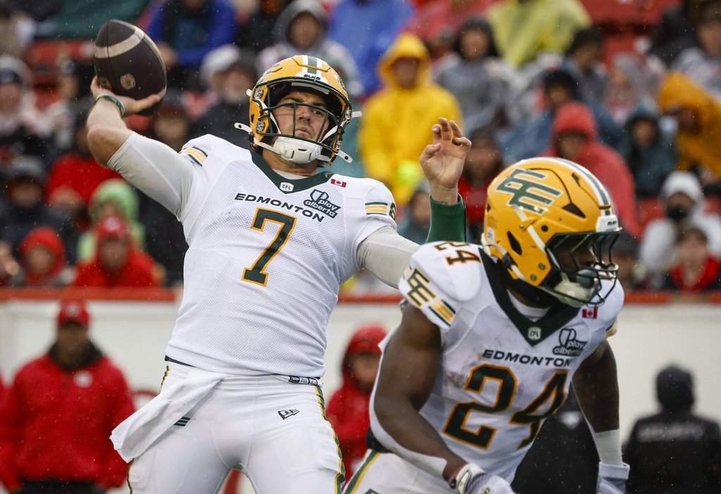 Edmonton Elks quarterback Cody Fajardo, left, throws the football during second half CFL football action against the Calgary Stampeders in Calgary, Monday, Sept. 7, 2026. THE CANADIAN PRESS/Jeff McIntosh.