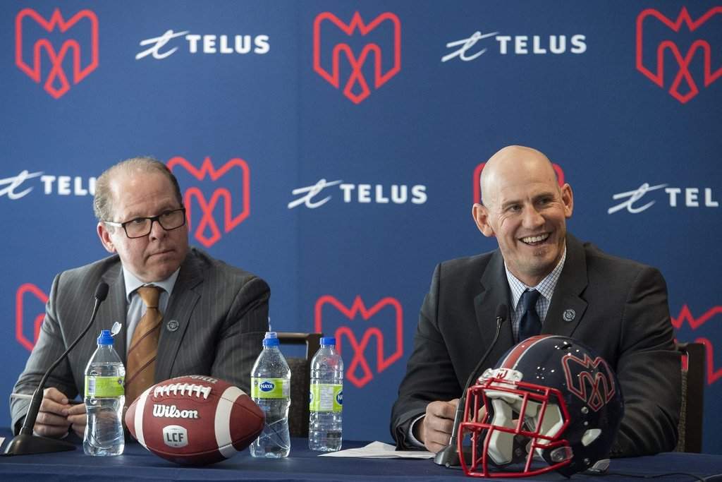 Jason Maas, right, smiles as he speaks during a news conference alongside Montreal Alouettes general manager Danny Maciocia in Montreal, Tuesday, December 20, 2022, announcing him as new head coach of the team. THE CANADIAN PRESS/Graham Hughes.