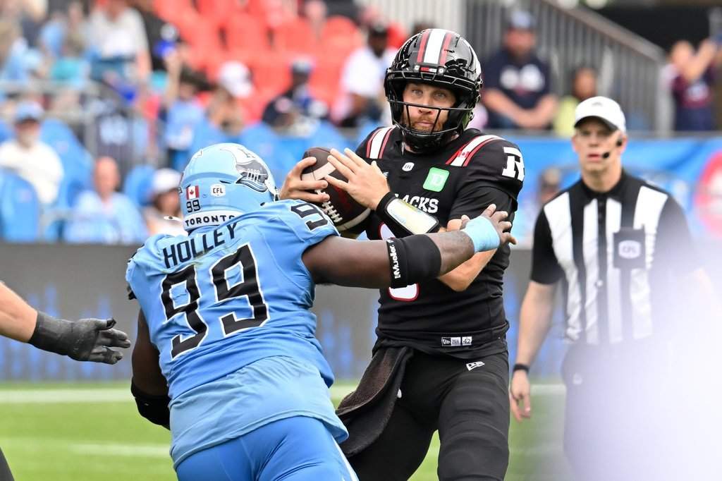 Ottawa Redblacks quarterback McLeod Bethel-Thompson (3) is sacked by Toronto Argos defensive tackle Ralph Holley (99) during second half CFL football action in Toronto on Saturday, Sept. 12, 2026. THE CANADIAN PRESS/Jon Blacker.