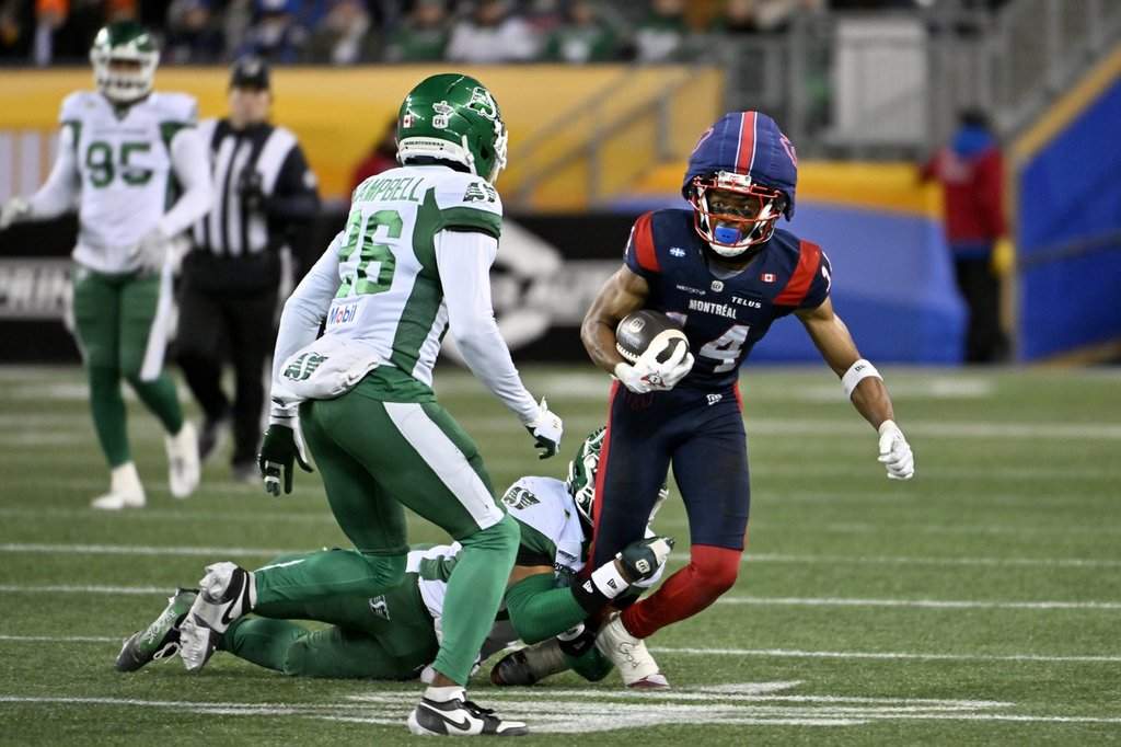 Montreal Alouettes' Charleston Rambo (14) gets taken down by Saskatchewan Roughriders' Antoine Brooks Jr. (33) during second half CFL football action at the 112th Grey Cup, in Winnipeg on Sunday, Nov. 16, 2025. THE CANADIAN PRESS/Fred Greenslade.