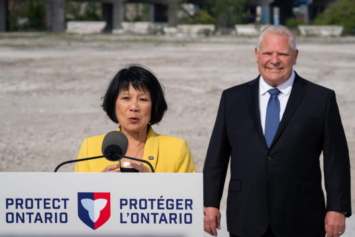Mayor of Toronto Olivia Chow speaks as Ontario Premier Doug Ford stands behind during an announcement regarding the Province uploading ownership and maintenance of the Gardiner Expressway and Don Valley Parkway, in Toronto on Thursday, June 4, 2026. 