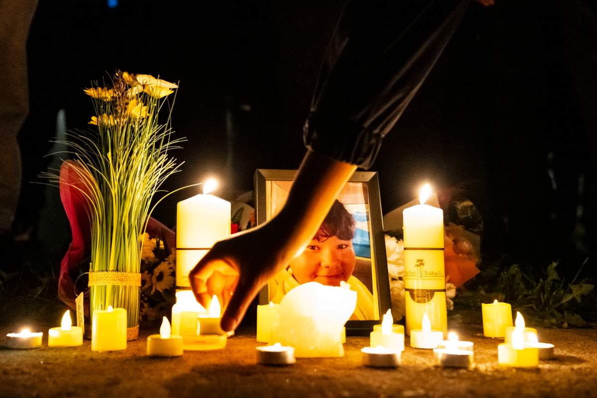 Family, friends and supporters of 15 year-old Nooran Rezayi place candles at his portrait at a vigil in his honour, in Longueuil, Que., on Monday, Sept. 21, 2026.
