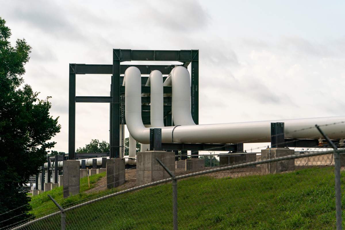 A pipeline runs toward oil storage tanks at the Cushing crude oil storage terminal in Cushing, Oklahoma, US, on Thursday, June 18, 2026.