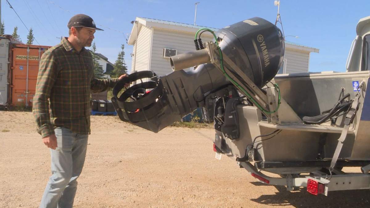 Kieran McIver with the beluga boat on dry land after another season of capturing images of Churchill’s beluga migration.