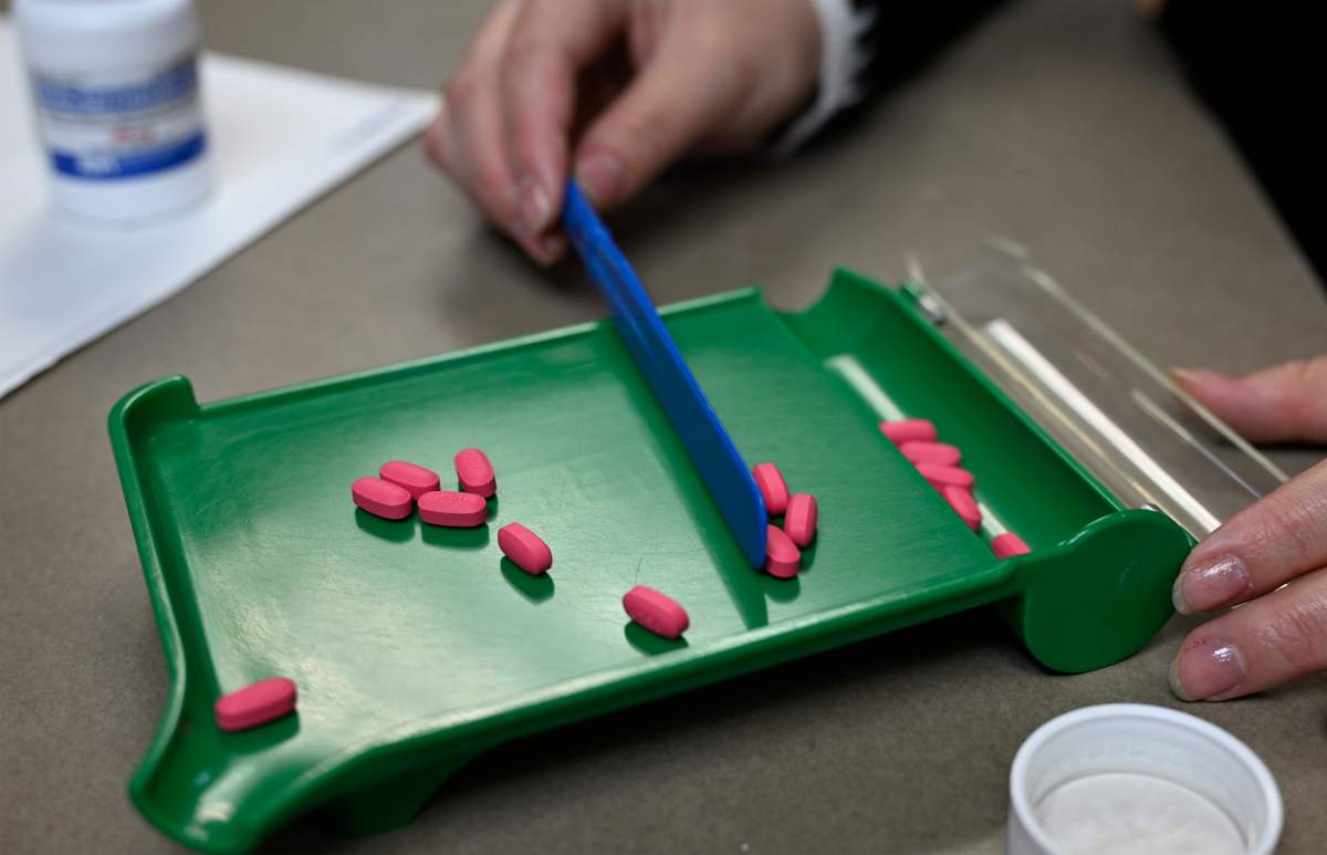 A pharmacy technician counts pills in Quebec City, Monday, Oct. 21, 2024. THE CANADIAN PRESS/Jacques Boissinot