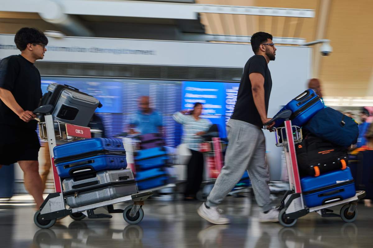Travellers pass by the Air Canada departure gates as flight attendants picket at Pearson International Airport in Toronto, on Monday, Aug. 18, 2025. THE CANADIAN PRESS/Sammy Kogan