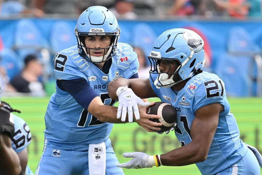 Toronto Argos quarterback Chad Kelly (12) hands off to running back Isaiah Smith (21) during first half CFL football action against the Ottawa Redblacks in Toronto on Saturday, Sept 12, 2026. THE CANADIAN PRESS/Jon Blacker.