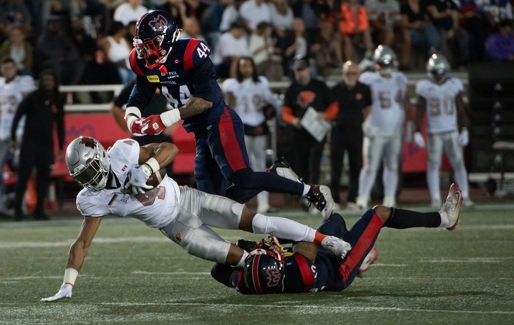B.C. Lions' Keon Hatcher Sr. (4) is tackled by Montreal Alouettes' Najee Murray (12) and Kylan Guidry (44) during first half CFL action in Montreal, Friday, Sept. 4, 2026. THE CANADIAN PRESS/Peter McCabe.
