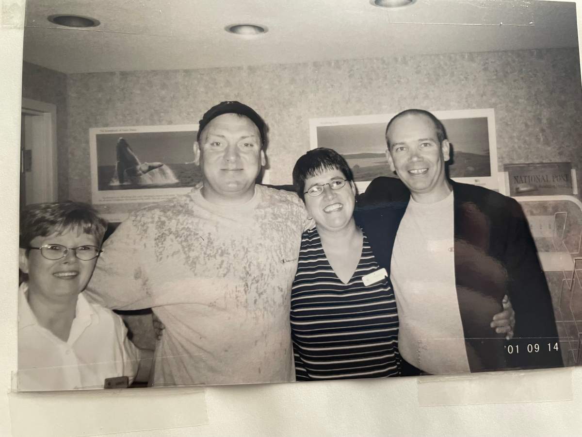 Karen Mills, who was the general manager of the Comfort Inn in Gander, NL, on Sept. 11, 2001, poses with two guests who stayed in the inn's gym after 38 planes were diverted to the small town.