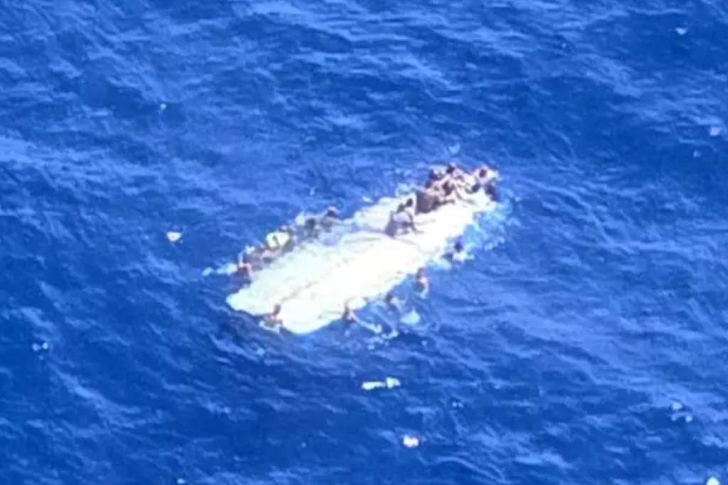 The U.S. Coast Guard said Monday that it has rescued at least 40 people in open waters after their boat capsized several miles from a tiny, uninhabited island west of Puerto Rico.