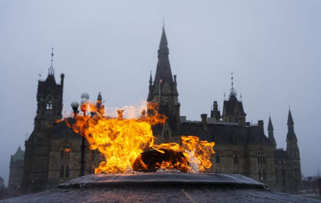 The West Block of Parliament Hill is pictured behind the Centennial Flame as a heavy fog hangs over downtown Ottawa on Thursday, April 16, 2026. 