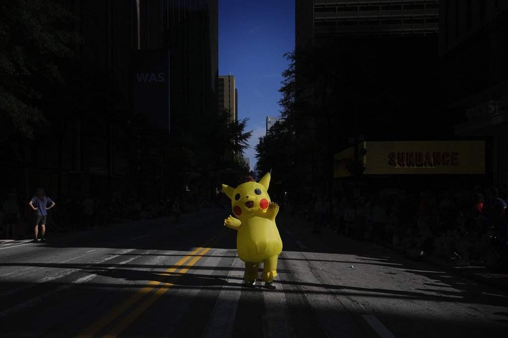 Kaito, of Atlanta, walks in a Pokemon, Pikachu costume during the Dragon Con parade on Saturday, Aug. 31, 2024, in Atlanta. (AP Photo/Brynn Anderson).