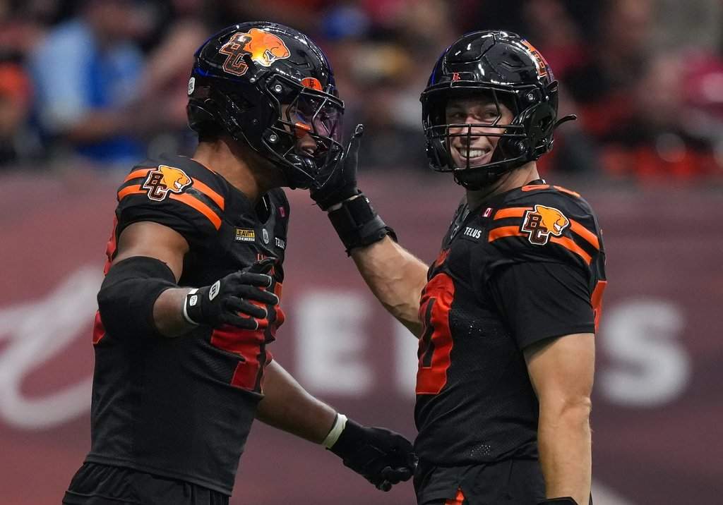 B.C. Lions' Mathieu Betts, right, and Hayden Harris celebrate after Betts sacked Toronto Argonauts quarterback Chad Kelly, not seen, during the first half of a CFL football game, in Vancouver, on Saturday, July 25, 2025. THE CANADIAN PRESS/Darryl Dyck.