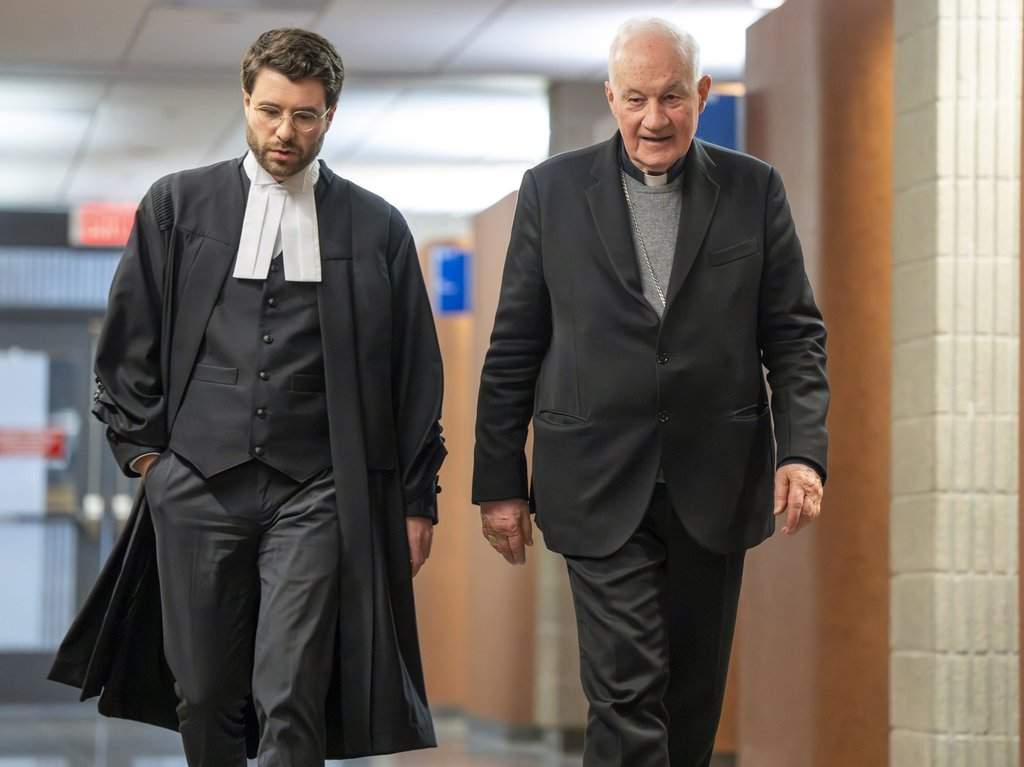 Quebec Cardinal Marc Ouellet, right, walks with one of his lawyers during a break at the courthouse in Montreal on Thursday, March 5, 2026. 