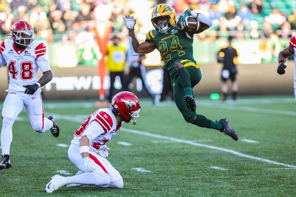 Edmonton Elks' ShunDerrick Powell (24) jumps over Calgary Stampeders' Ben Labrosse (29) during first half CFL football action in Edmonton on Saturday, Sept. 12, 2026. THE CANADIAN PRESS/Codie McLachlan.