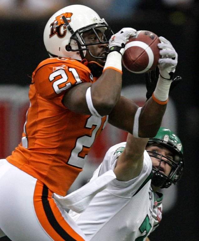 B.C. Lions' Ryan Phillips, left, intercepts a pass intended for Saskatchewan Roughriders' Weston Dressler during first half CFL action in Vancouver, B.C., on Friday October 2, 2009. THE CANADIAN PRESS/Darryl Dyck.
