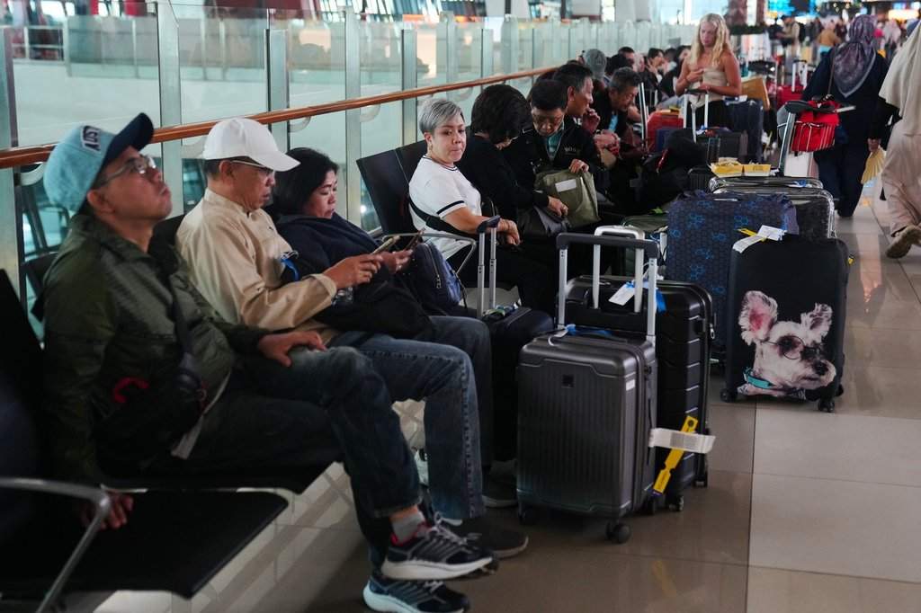 Travelers wait for their flights at Soekarno-Hatta International Airport in Tangerang, Indonesia, Sunday, Sept. 6, 2026. 