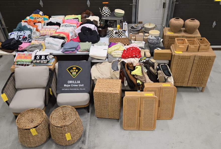 Piles of clothes and furniture seized in an Ontario Provincial Police investigation are shown in an undated handout photo. Provincial police say a 34-year-old woman who was first arrested in May following complaints of theft and fraud at an Orillia hospital is now facing 65 new charges. 
