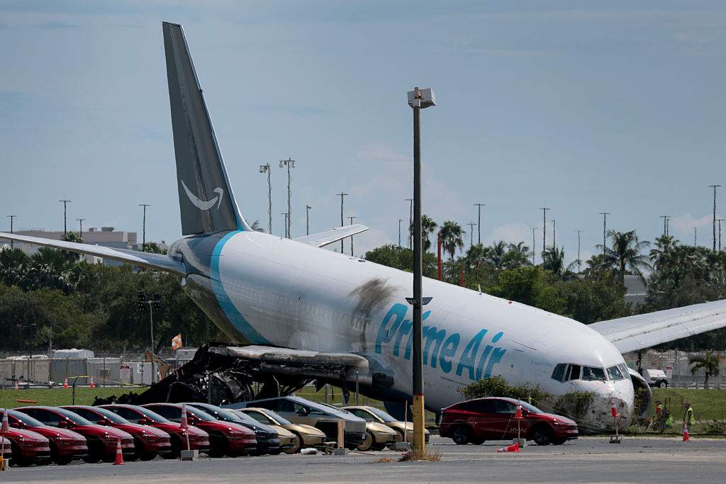 Investigators continue work to determine what caused the crash of an Amazon cargo plane at Miami International Airport on September 07, 2026 in Miami, Florida. According to reports, at least five people died, and five others were injured during the crash. The Federal Aviation Administration said Prime Air Flight 7598 overran the runway while landing around 2 p.m. on September 6th after departing from Luis Muñoz Marín International Airport in San Juan, Puerto Rico.