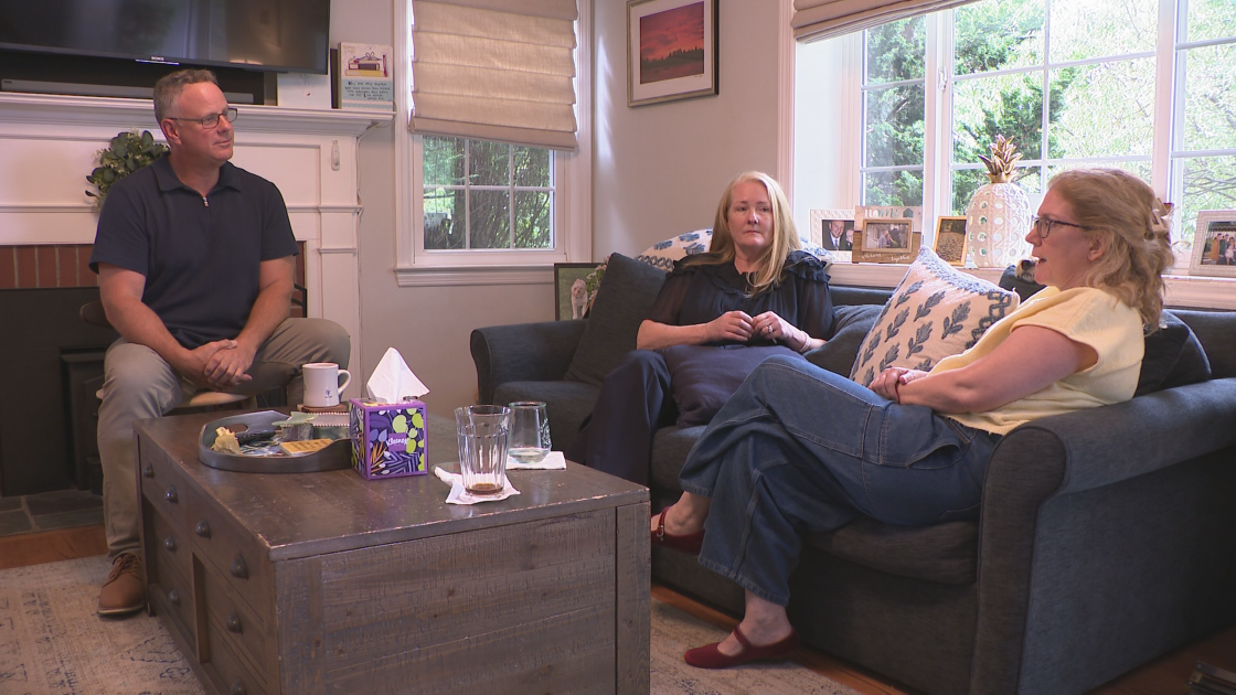 Global News reporter Mike Armstrong sits and listens to the family of Michael J. Armstrong.