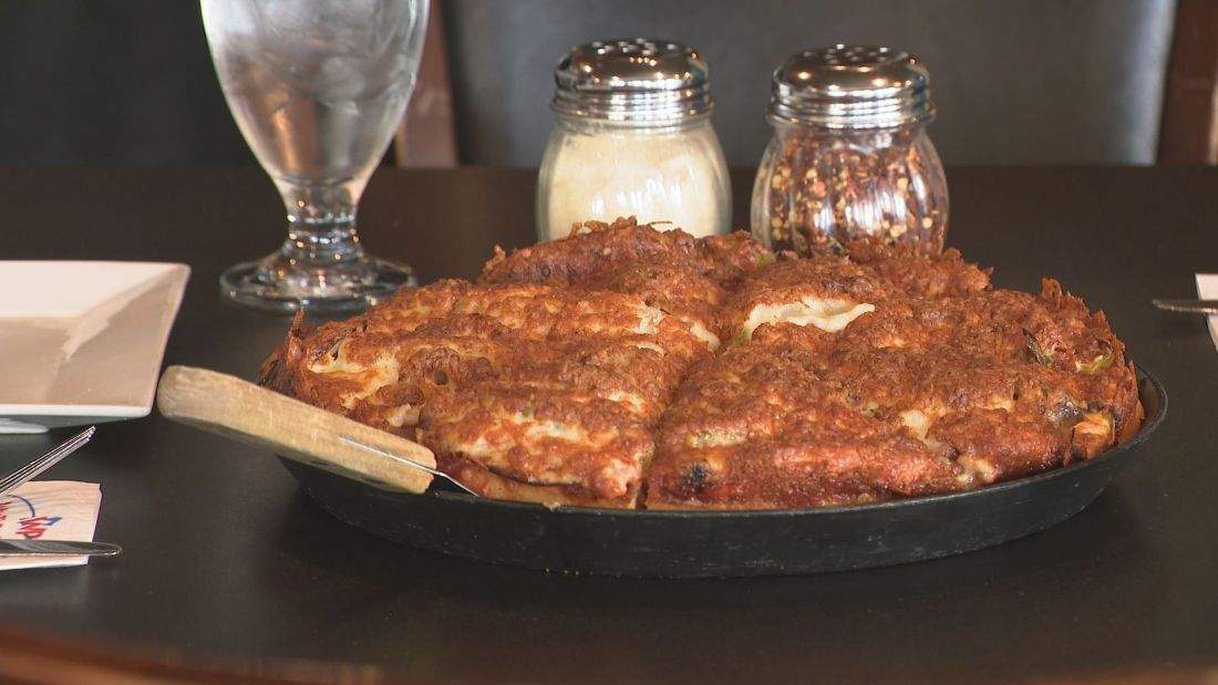 A Regina-style pizza has layers of meat, cheese and other toppings.