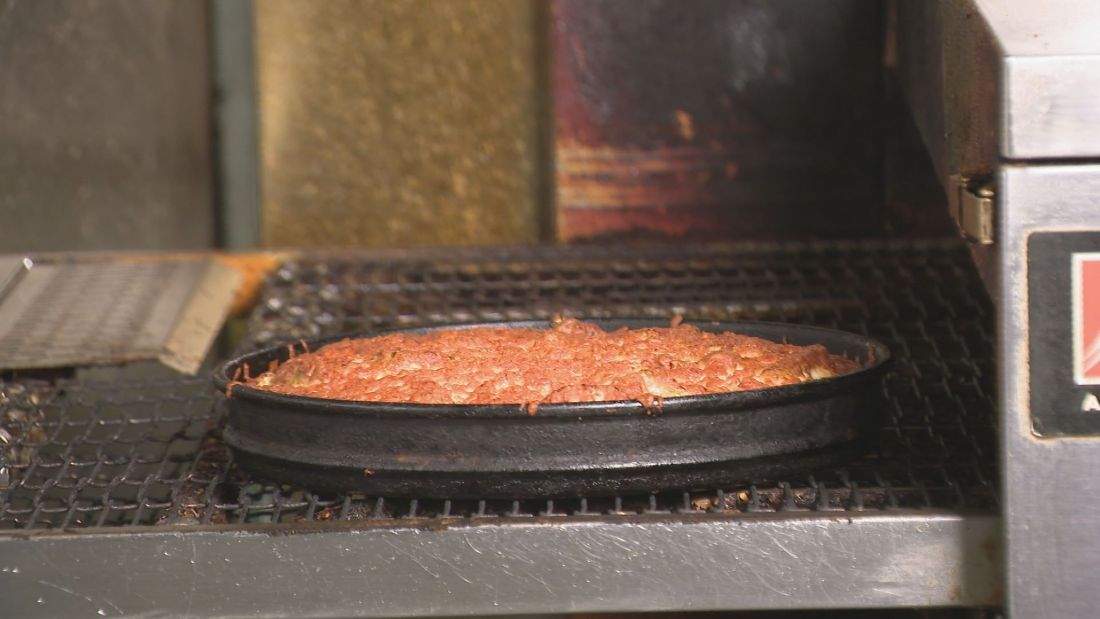 A Regina-style pizza has layers of meat, cheese and other toppings.