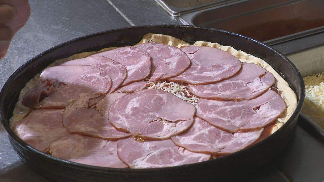 A Regina-style pizza has layers of meat, cheese and other toppings.