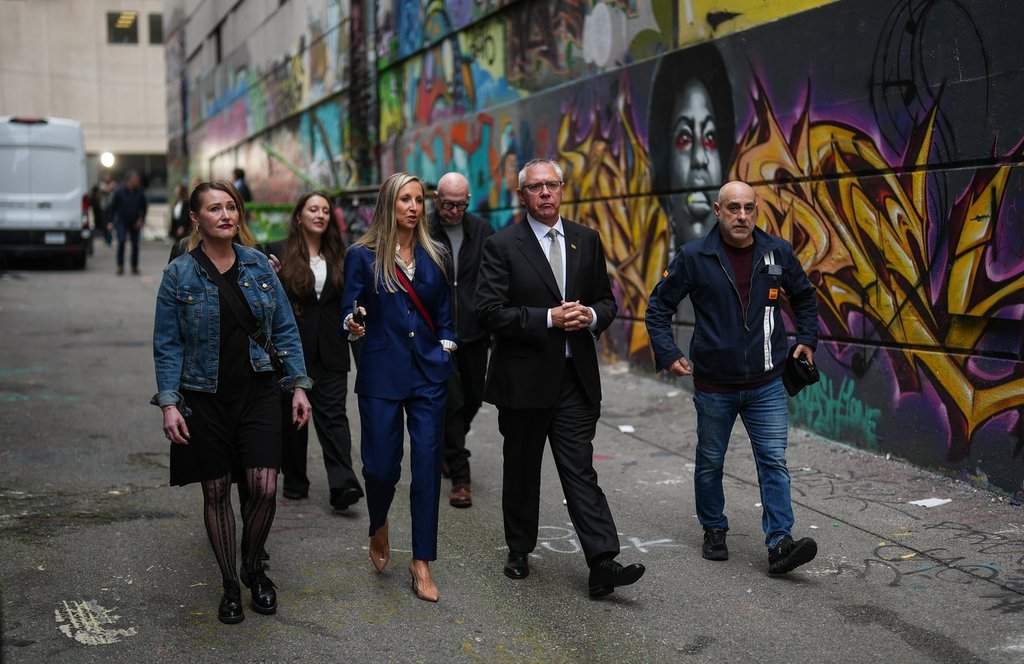 B.C. Conservative interim Leader Lorne Doerkson, third left, walks with supporters after a provincial election campaign announcement in an alley in downtown Vancouver, on Tuesday, Oct. 6, 2026. 