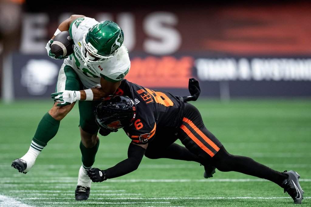 Saskatchewan Roughriders' Johnny Johnson III (88) is pushed out by BC Lions' TJ Lee (6) during the first half of a CFL football game in Vancouver on Sunday, Aug. 23, 2026. THE CANADIAN PRESS/Ethan Cairns.