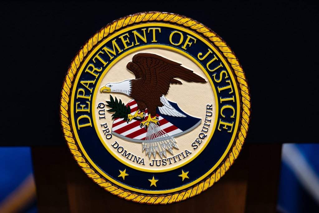 The U.S. Department of Justice logo is seen on a podium before a news conference, Monday, May 4, 2026, in Washington. THE CANADIAN PRESS/AP-Julia Demaree Nikhinson.
