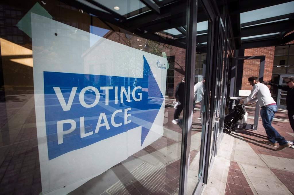 People enter a municipal election polling station in Vancouver, on Saturday, Oct. 20, 2018. THE CANADIAN PRESS/Darryl Dyck.
