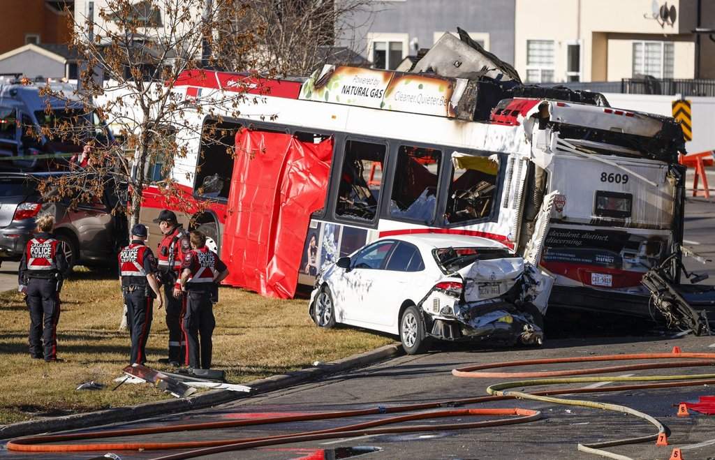 Police and fire personnel attend the scene of a fatal bus crash in Calgary, Thursday, Oct. 15, 2026.