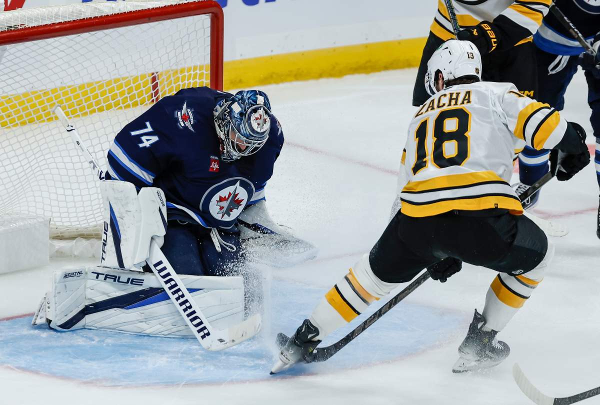 Winnipeg Jets goaltender Stuart Skinner (74) saves the shot from Boston Bruins' Pavel Zacha (18) during second period NHL hockey action in Winnipeg on Friday, Oct. 2, 2026. THE CANADIAN PRESS/John Woods.