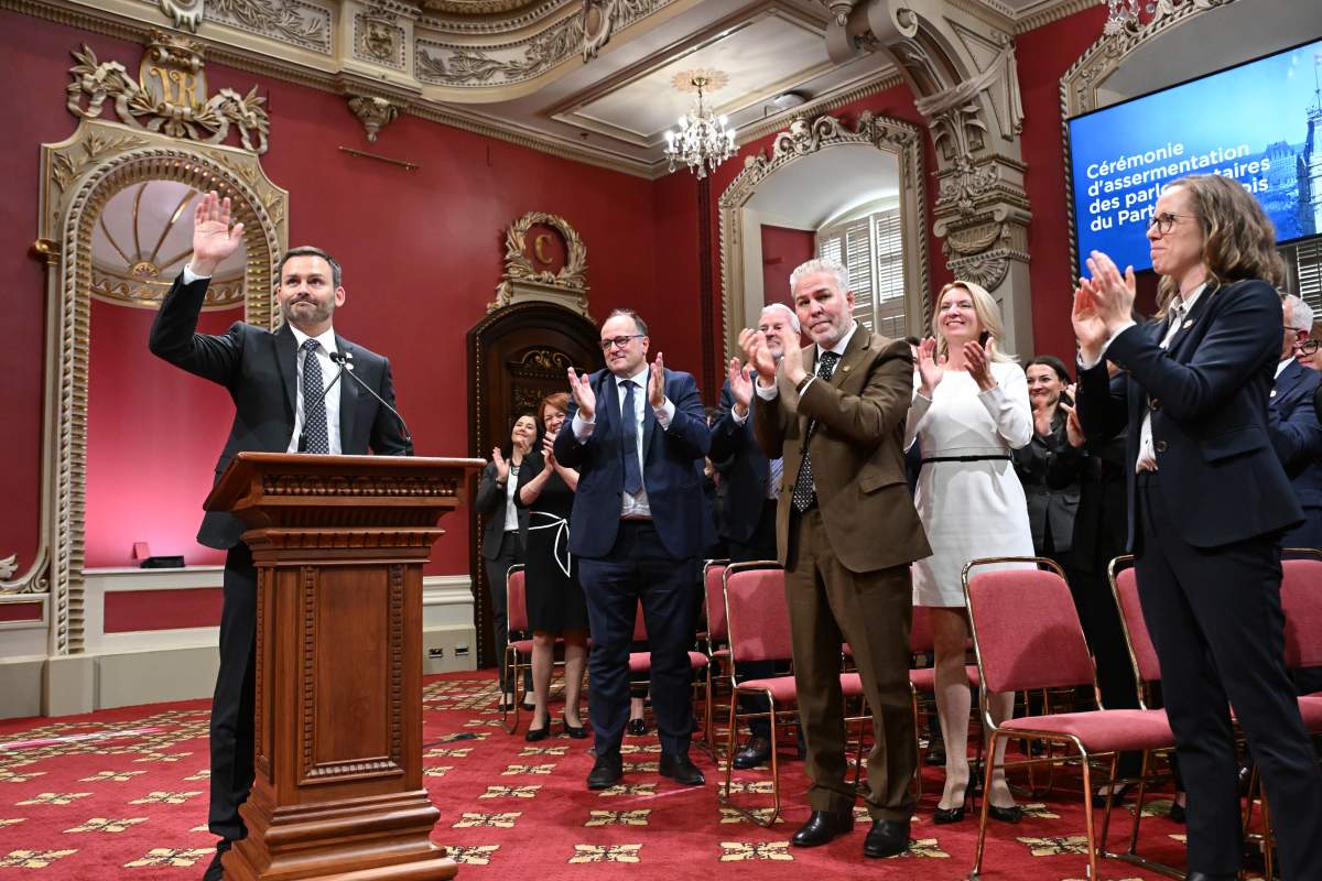 Quebec Premier Paul St-Pierre Plamondon waves as he is applauded by sworn-in members at the legislature in Quebec City, Thursday, Oct. 15, 2026.