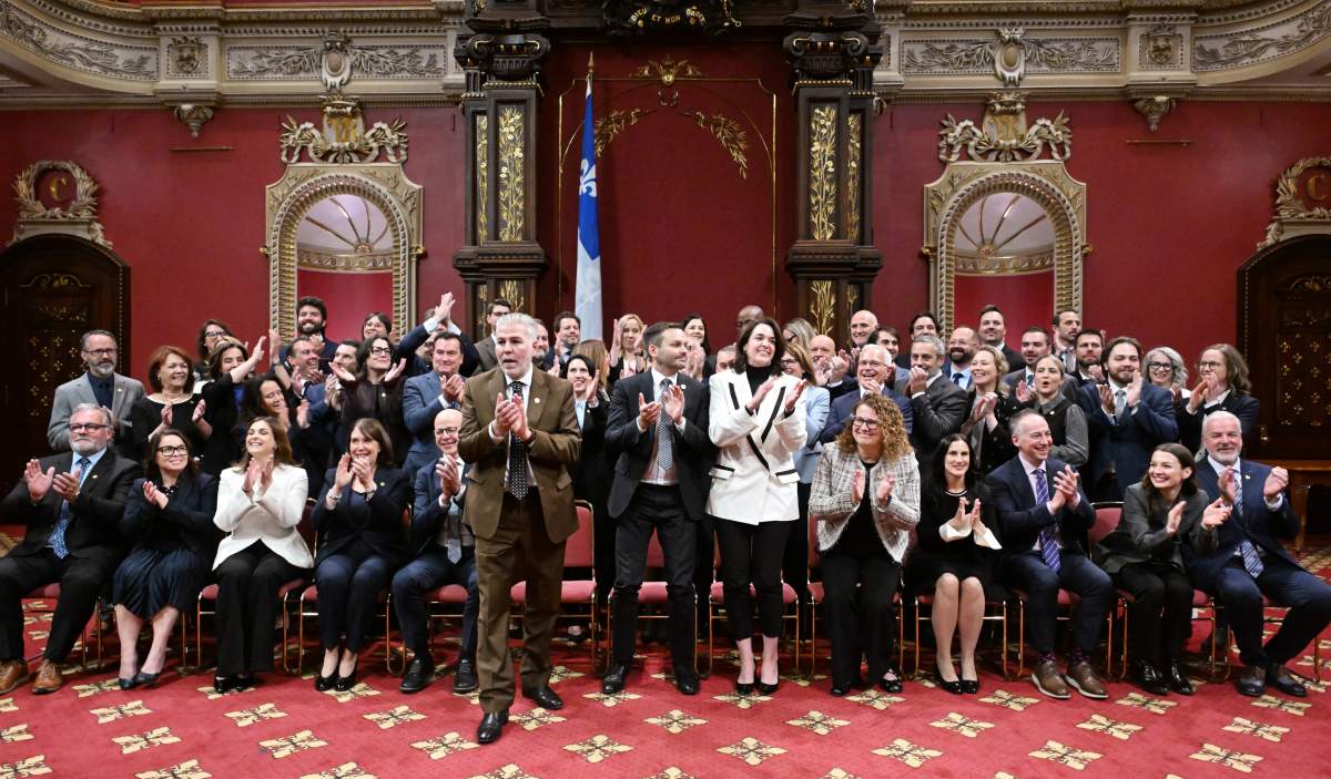 Quebec Premier Paul St-Pierre Plamondon, centre, applauds with Parti Québécois elected members following a swearing-in ceremony at the legislature in Quebec City, Thursday, Oct. 15, 2026.