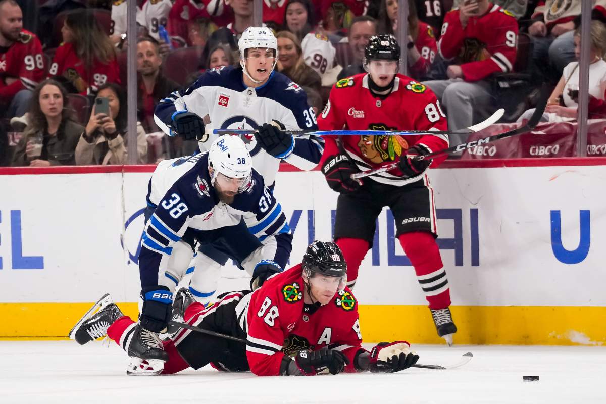 Chicago Blackhawks right wing Patrick Kane (88) looks at the puck after being checked by Winnipeg Jets defenseman Mario Ferraro (38) during the first period of an NHL hockey game, Thursday, Oct. 15, 2026, in Chicago. (AP Photo/Harry Figiel).
