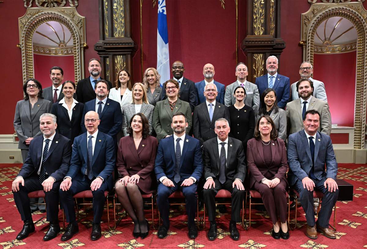 Quebec Premier Paul St-Pierre Plamondon, centre sits with his new cabinet for the official picture at the legislature, with from left, first row, Pascal Berube, Joel Arseneau, Catherine Gentilcore, Paul St-Pierre Plamondon, Nicolas Marceau, Marie-Claude Sarrazin, Alain àTherrien, second row, Nadine Le Gal, Nathalie Bisaillon, Mathieu Lebrun, Elsie Lefebvre, Marie-Karlynn Laflamme, Stephane Paquet, Meganne Perry-Melancon, Anne Nguyen, William Fradette, third row, Jean Pellerin, Simon-Pierre Savard-Tremblay, Meggie Richard, Camille Pellerin-Forget, Dieudonne Ella Oyono, Guy Jr. Lapointe, Guy Jr. Lapointe, Bernard Sevigny, Sebastien D’Astous, in Quebec City Wednesday, Oct. 21, 2026.