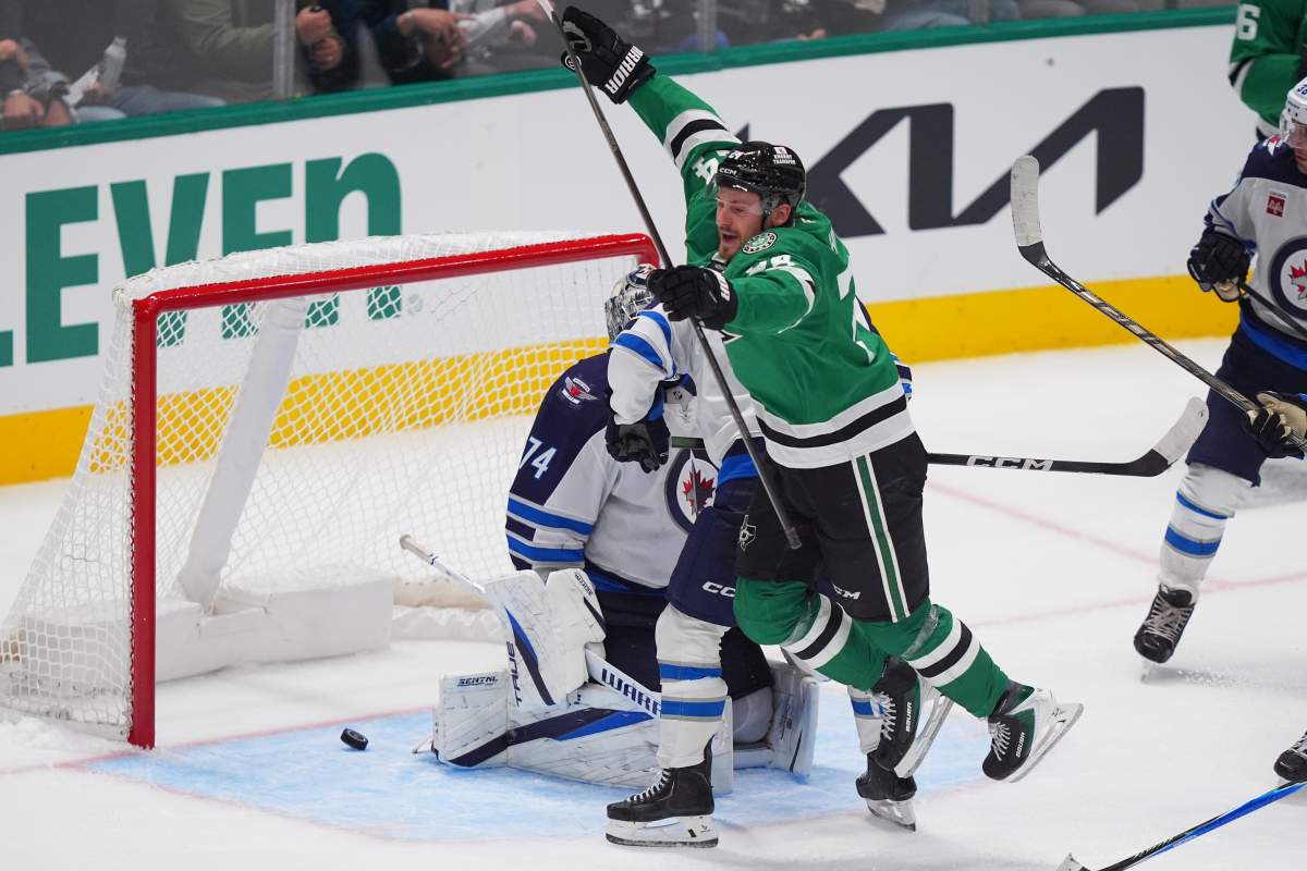 Dallas Stars center Roope Hintz (24) jumps after scoring a goal against Winnipeg Jets goaltender Stuart Skinner (74) during the third period of an NHL hockey game Thursday, Oct. 22, 2026, in Dallas. (AP Photo/LM Otero).