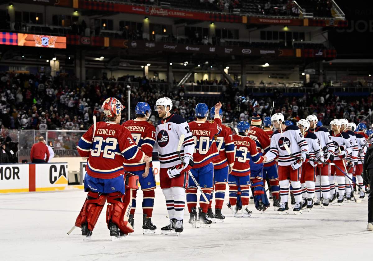 Winnipeg Jets' Adam Lowry (17) and Montreal Canadiens' goaltender Jacob Fowler (32) shake hands at the end of the NHL Heritage Classic game in Winnipeg on Sunday, Oct. 25, 2026. THE CANADIAN PRESS/Fred Greenslade.