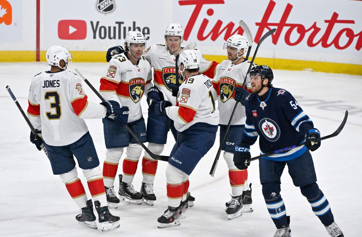 Florida Panthers' Carter Verhaeghe (23) celebrates his goal against the Winnipeg Jets with Seth Jones (3), Brady Tkachuk (8), Matthew Tkachuk (19) and Sam Reinhart (13) during first period NHL action in Winnipeg on Tuesday, Oct. 27, 2026. THE CANADIAN PRESS/Fred Greenslade.