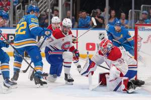 St. Louis Blues' Pius Suter (22) skates near a loose puck as Montreal Canadiens goaltender Jacob Fowler (32) and Kirby Dach (77) defend during the second period of an NHL hockey game Tuesday, Oct. 27, 2026, in St. Louis.